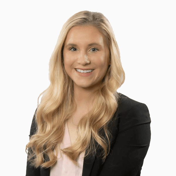 Professional portrait of a smiling woman with long blonde hair wearing a black blazer.