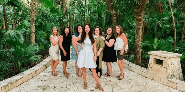 Group of women posing together outdoors for Travel Agency Reviews.