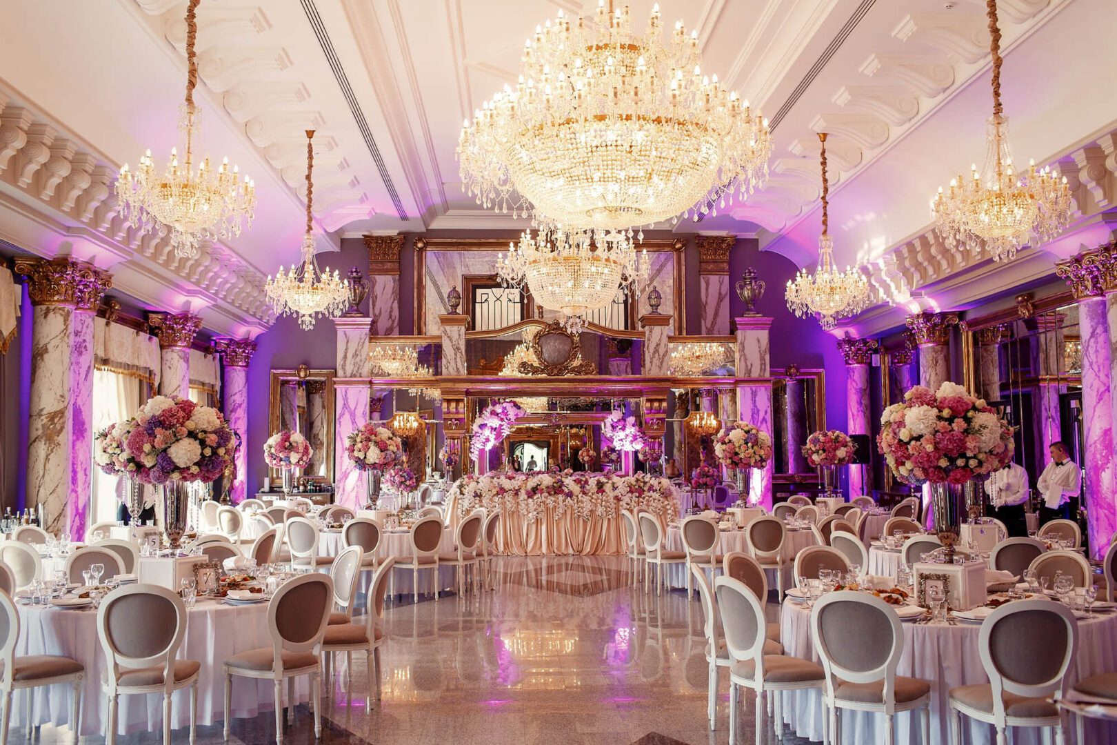An elegant dinner hall with a large crystal chandelier