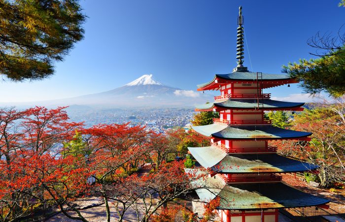 Chureito pagoda with mount fuji in the background amidst colorful autumn foliage.