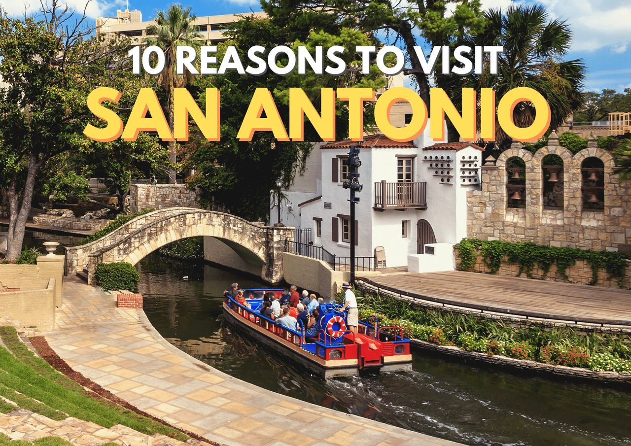 Tourists enjoy a boat tour along the san antonio river walk with historical buildings in the background.