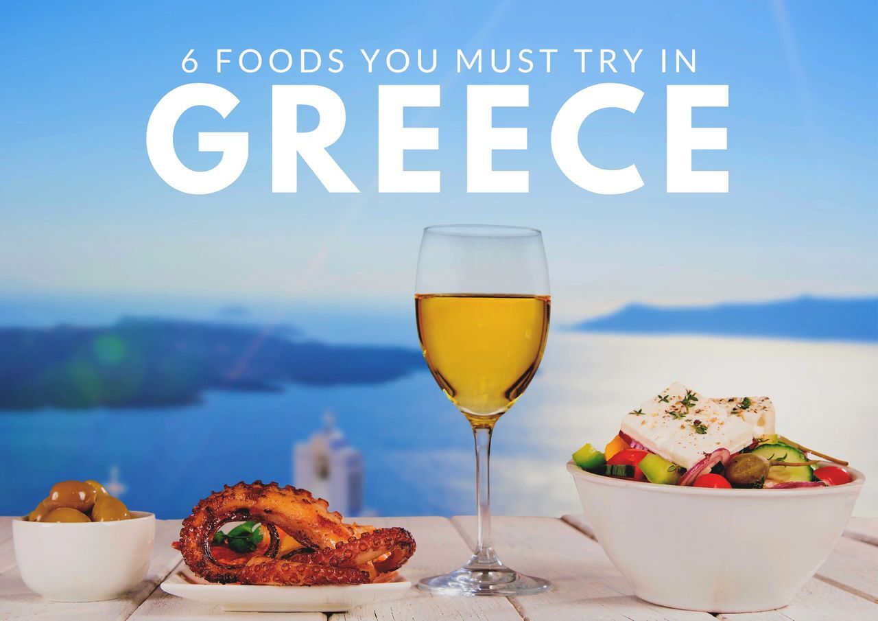 A picturesque greek meal with a view of the sea, highlighting "6 foods you must try in greece.