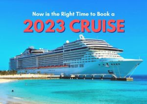 Large cruise ship docked at a tropical destination with an advertisement for booking cruises in 2023.