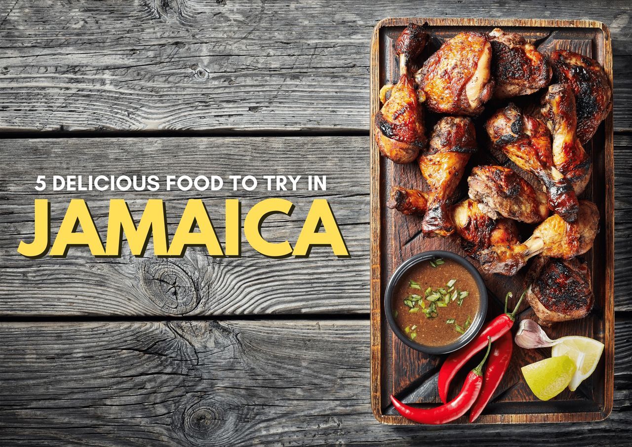 Grilled jerk chicken on a tray with sauce and spices, showcasing jamaican cuisine.