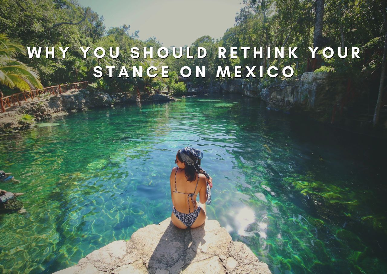 Woman contemplating a serene cenote in a lush setting.