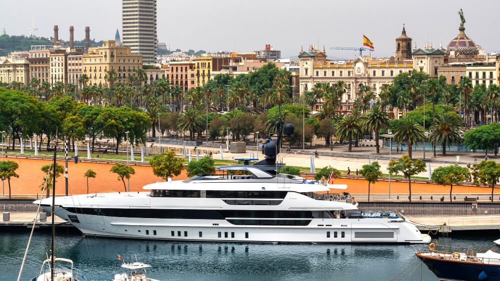 A luxury yacht moored in a Mediterranean harbor