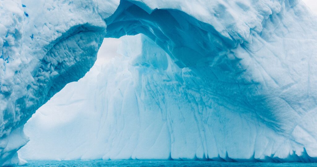 A sculpted blue ice arch in Antarctica