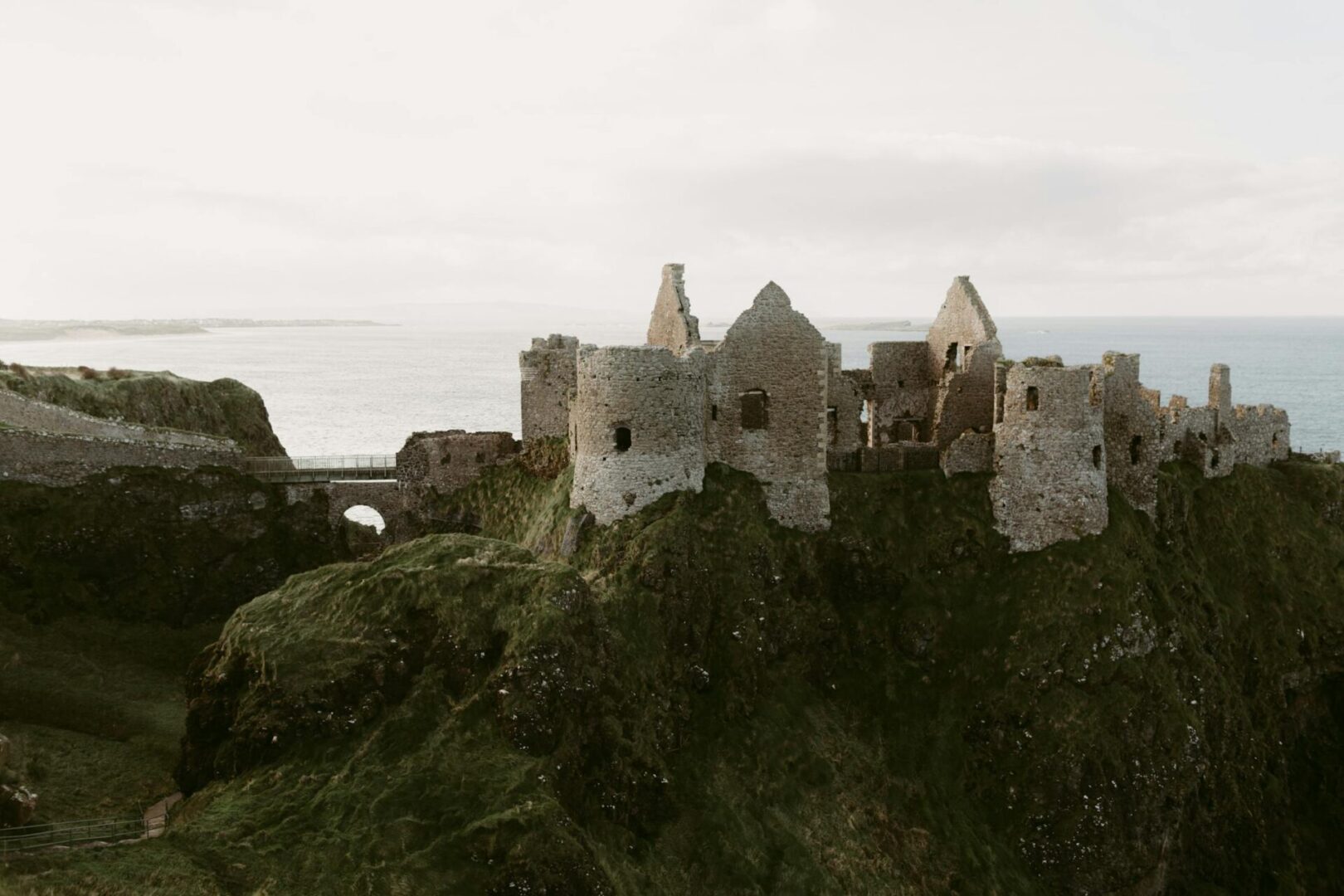 The ruins of Dunluce Castle on a cliff above the sea