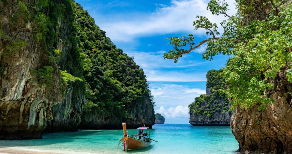 A longtail boat in a turquoise bay in Thailand