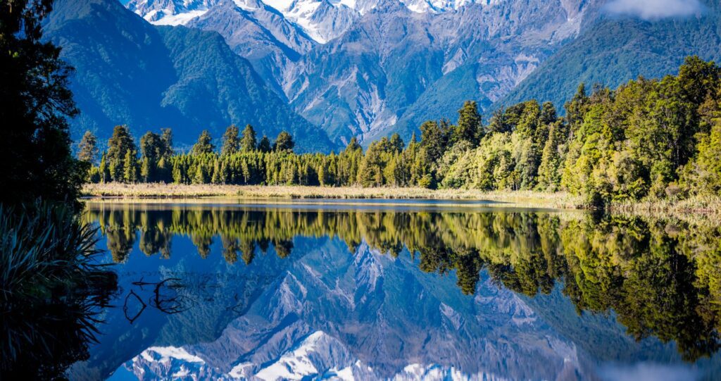 Snowy peaks reflected in a still lake in New Zealand