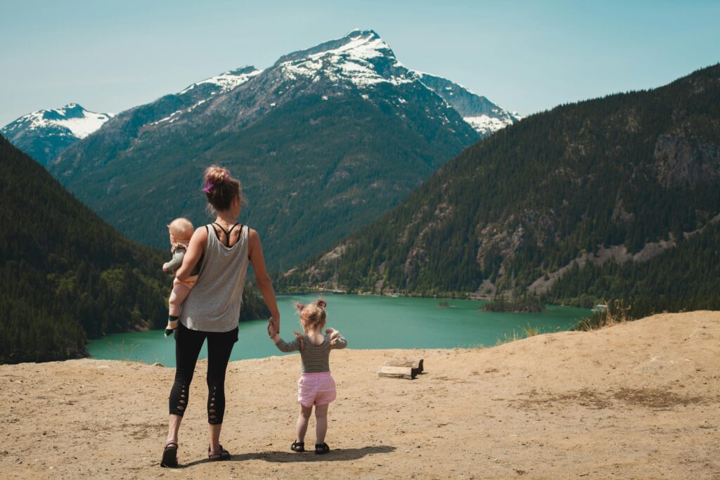 A parent and child taking in a mountain view together