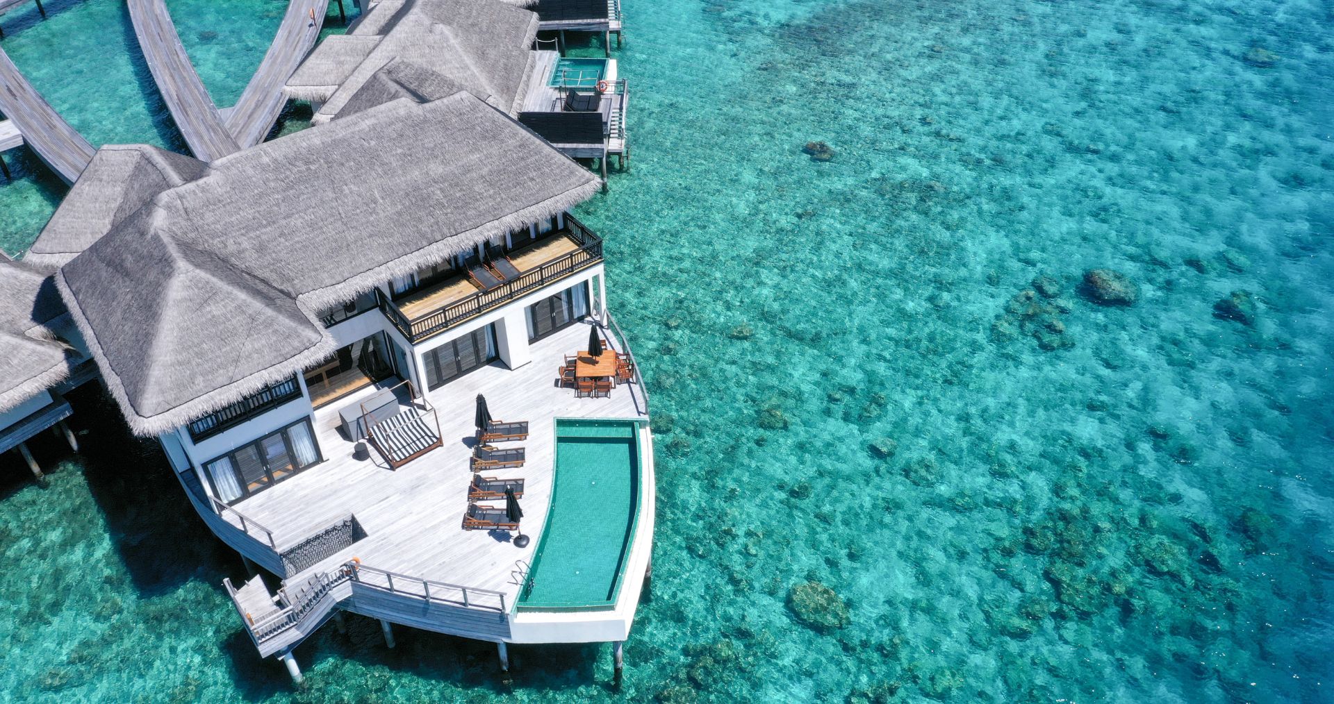 Overwater villas above a turquoise lagoon
