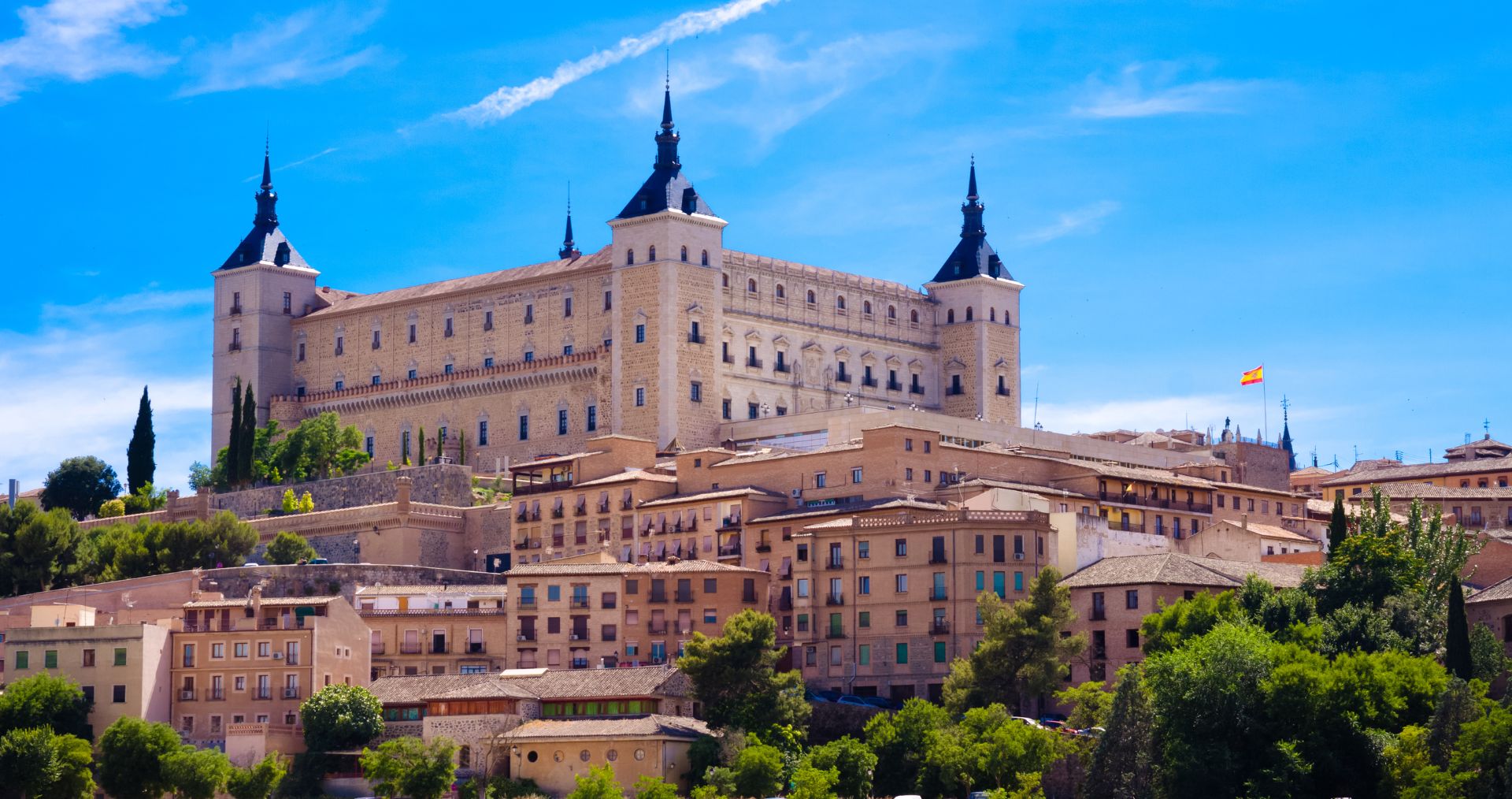 Toledo’s Alcázar crowning the hilltop old town under a blue sky
