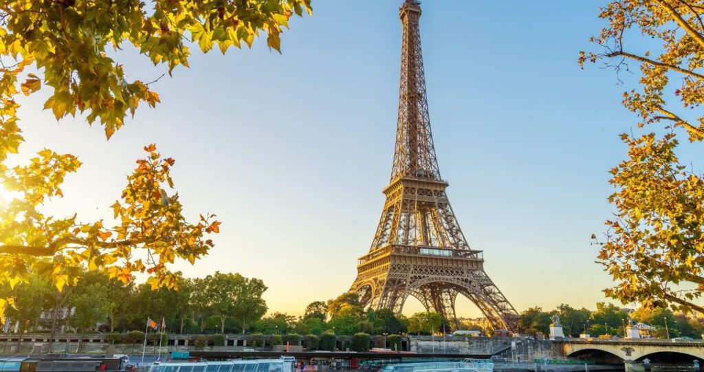 The Eiffel Tower framed by trees in Paris
