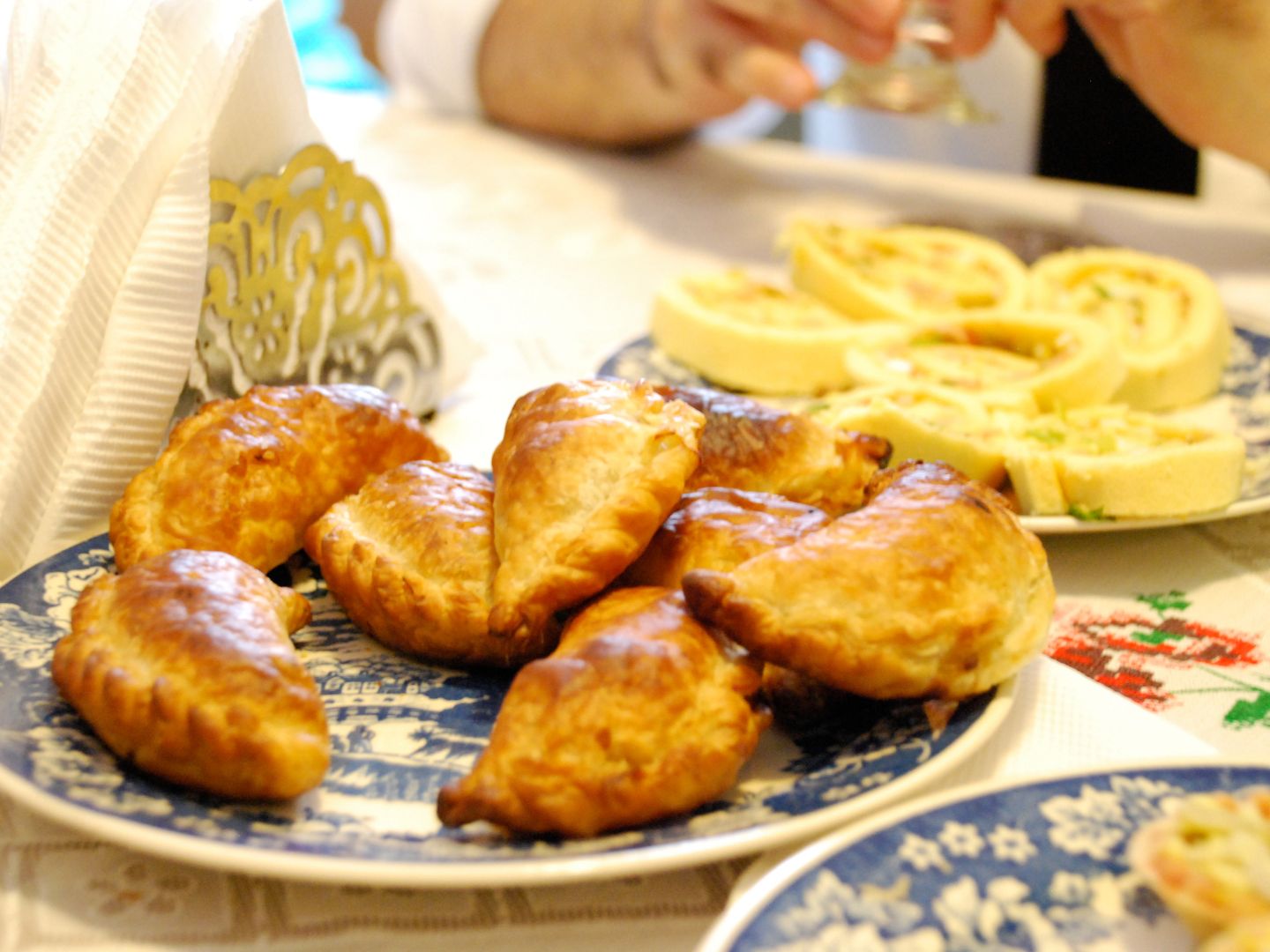 Golden Spanish empanadillas served on a patterned plate