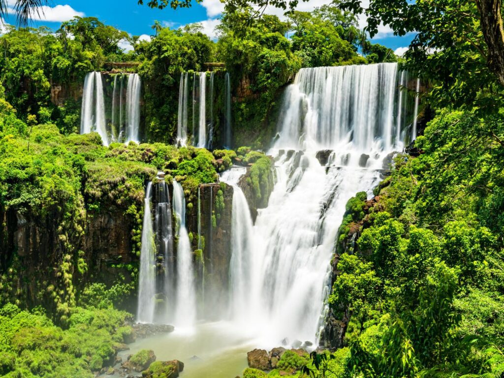 Iguazú Falls cascading through green rainforest