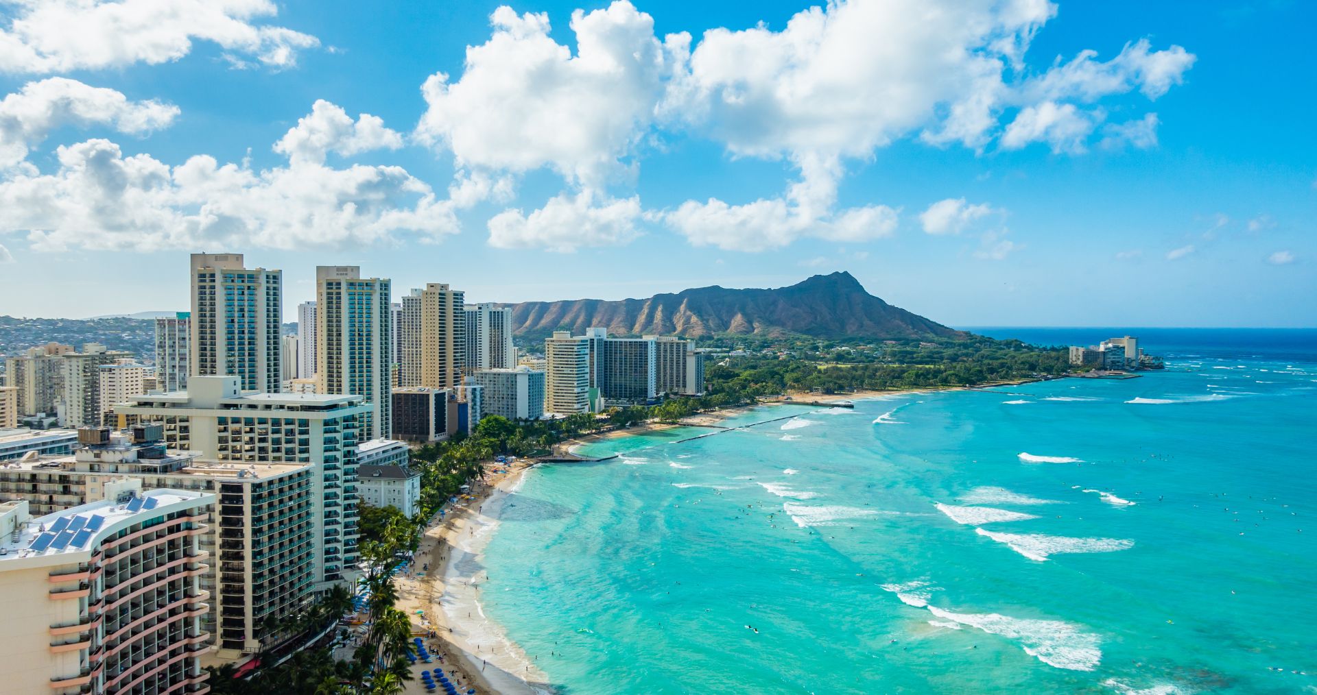 Waikiki Beach lined with hotels beneath Diamond Head