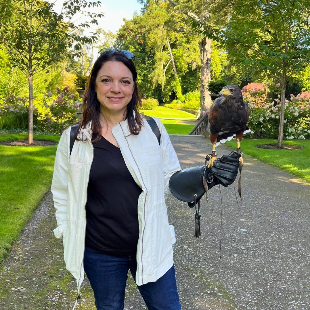 A Travel Byrds advisor holding a hawk on a gloved hand during a falconry experience in Ireland