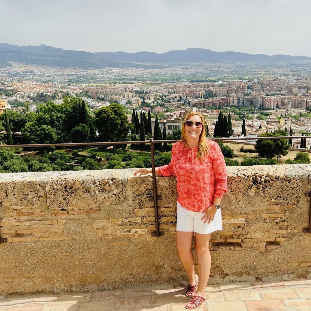 A Travel Byrds advisor at a hilltop viewpoint overlooking a Spanish city
