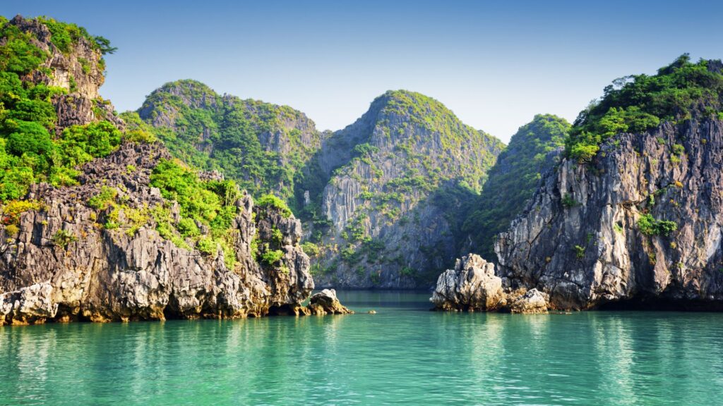 Limestone karsts rising from the emerald water of Halong Bay