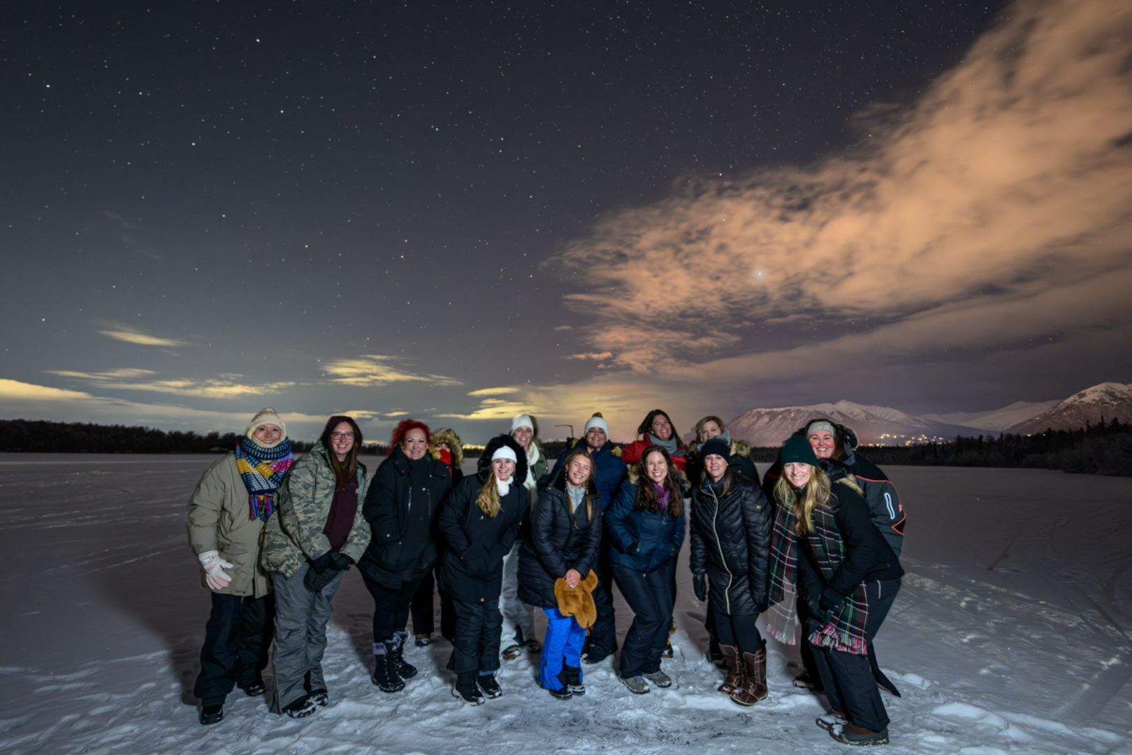 A group gathered together on a winter trip in Alaska