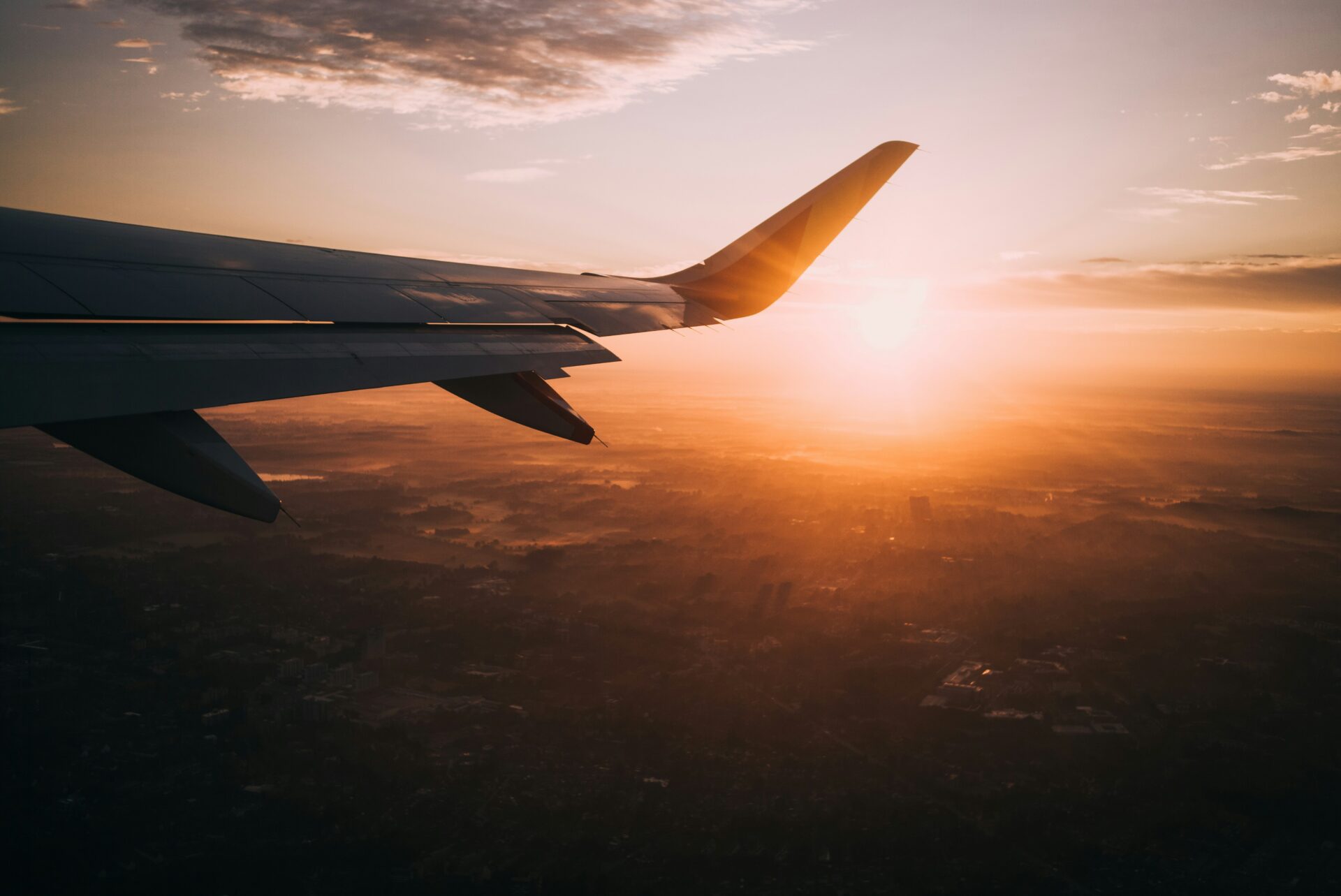 Airplane wing at sunset