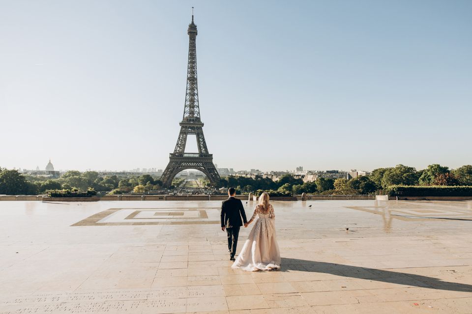 Couple walking toward the Eiffel Tower in Paris