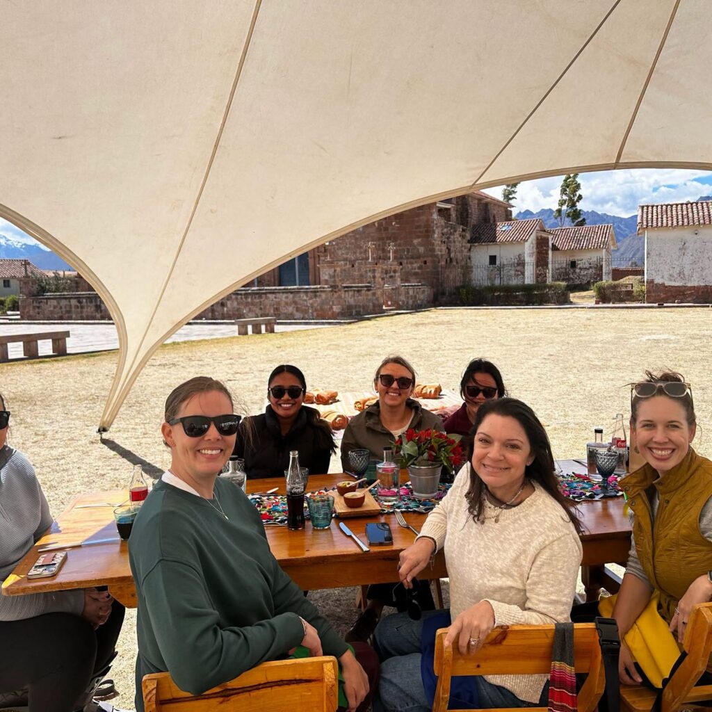 Travel Byrds team at a long outdoor lunch in the Andes
