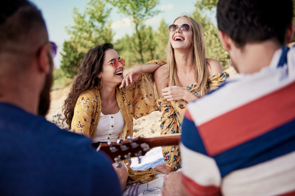 Friends sharing a meal and laughing together outdoors