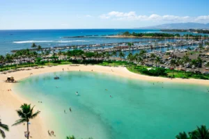 Aerial view of a public beach lined with resorts in Wailea, Maui