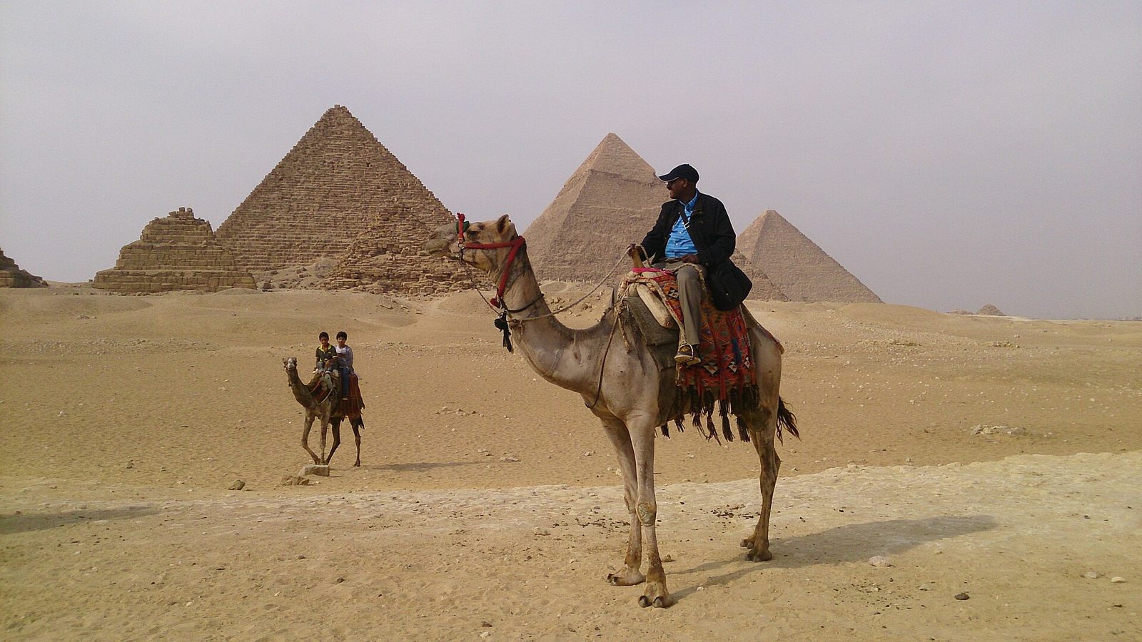 Camel ride on the Giza Plateau with the pyramids behind