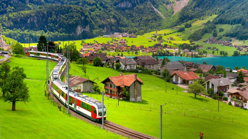 Scenic train winding through a green Swiss valley